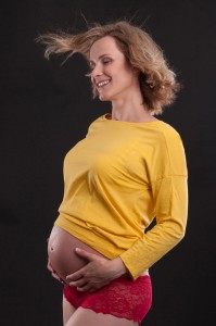 Wind blowing through hair of happy pregnant mother pregnancy photography by Anais Chaine Auckland Photographer