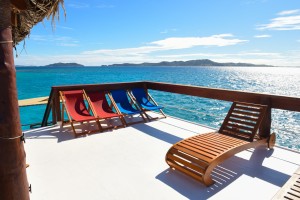 Sun loungers on the boat's terrace with a beautiful landscape in the background Fiji
