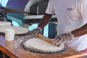 On the boat a Cloud 9's member stretching the pizza dough