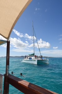 Composition with burlap flap of the bar and a big catamaran sailing