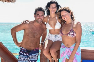 Three guests posing on the Cloud 9 bar island in Fiji Nadi