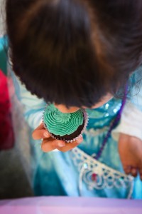child eating a cup cake taken from above