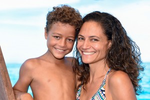 Mother and son smile at the camera aboard Cloud 9 Fiji