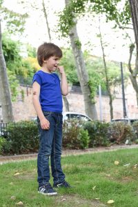 young boy Standing up fingers in the mouth