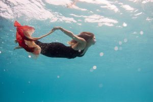 Woman photographed underwater with dress