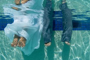 feet of a couple underwater in the swimming pool of the westin hotel in Denerau island Fiji