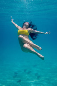 Woman posing underwater in Fiji