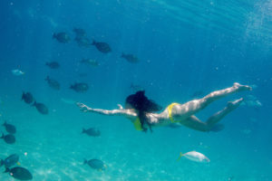 Woman swimming with the fishes underwater