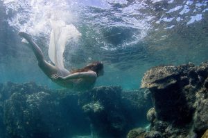 Bride swimming by coral in Fiji