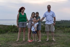 Family hug in Fiji countryside for family photoshoot