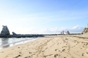 Wideshot of family strolling on stunning Fiji beaches in Malolo village