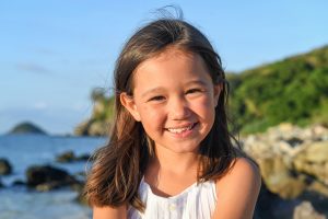 Stunning brunette little girl on the beach in Malolo Fiji Castaway Island