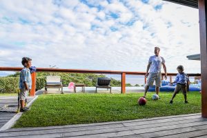 Dad stops soccer ball during Fiji family vacation