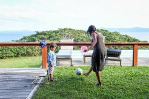 Polynesian mom plays soccer with son during Fiji family vacation