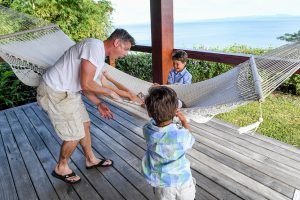 Triplets and dad excited over hammock during Fiji family vacation