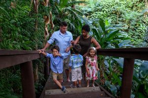 Triplets with their family in tropical rain forest during Fiji family vacation