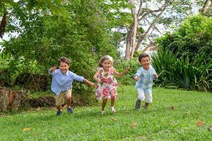 Triplets run on lawn in Family vacation Fiji