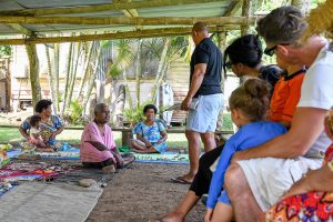 Mixed race family in Fiji traditional meeting