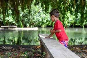 Boys play on park bench in Fiji family vacation