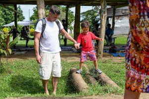 Dad supports son as he walks on pipes in Fiji