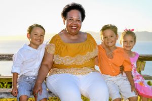 Grandma poses with triplet grandchildren in sunset in family photoshoot