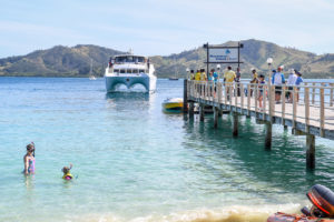 A cruise ship arrives at the dock at Plantation Island Resort Fiji