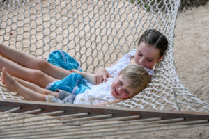 Brother and sister swing on hammock at Malolo Island Resort