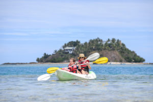 Mother and daughter paddle on the shallow waters at Malolo Island