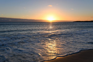 The golden sun sets behind the Pacific ocean in Denarau Fiji