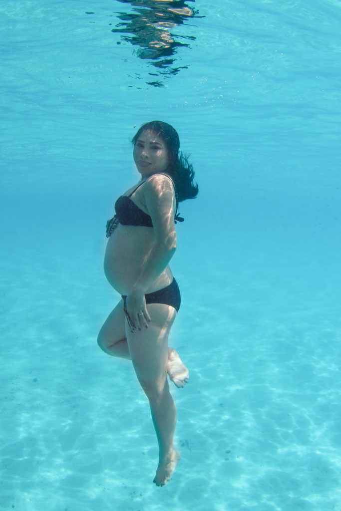 Stunning underwater pregnancy bikini portrait