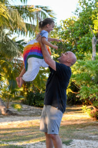 Father tosses daughter in the air