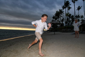 Children racing at the beach in Fiji for the family photoshoot