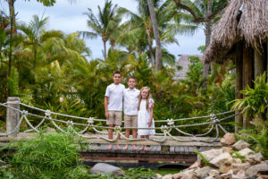 Siblings portrait posing on the bridge by the palm trees