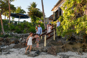 Family walking down the stairs to go to the beach in Fiji
