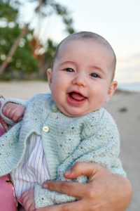 portrait of a baby laughing on the beach