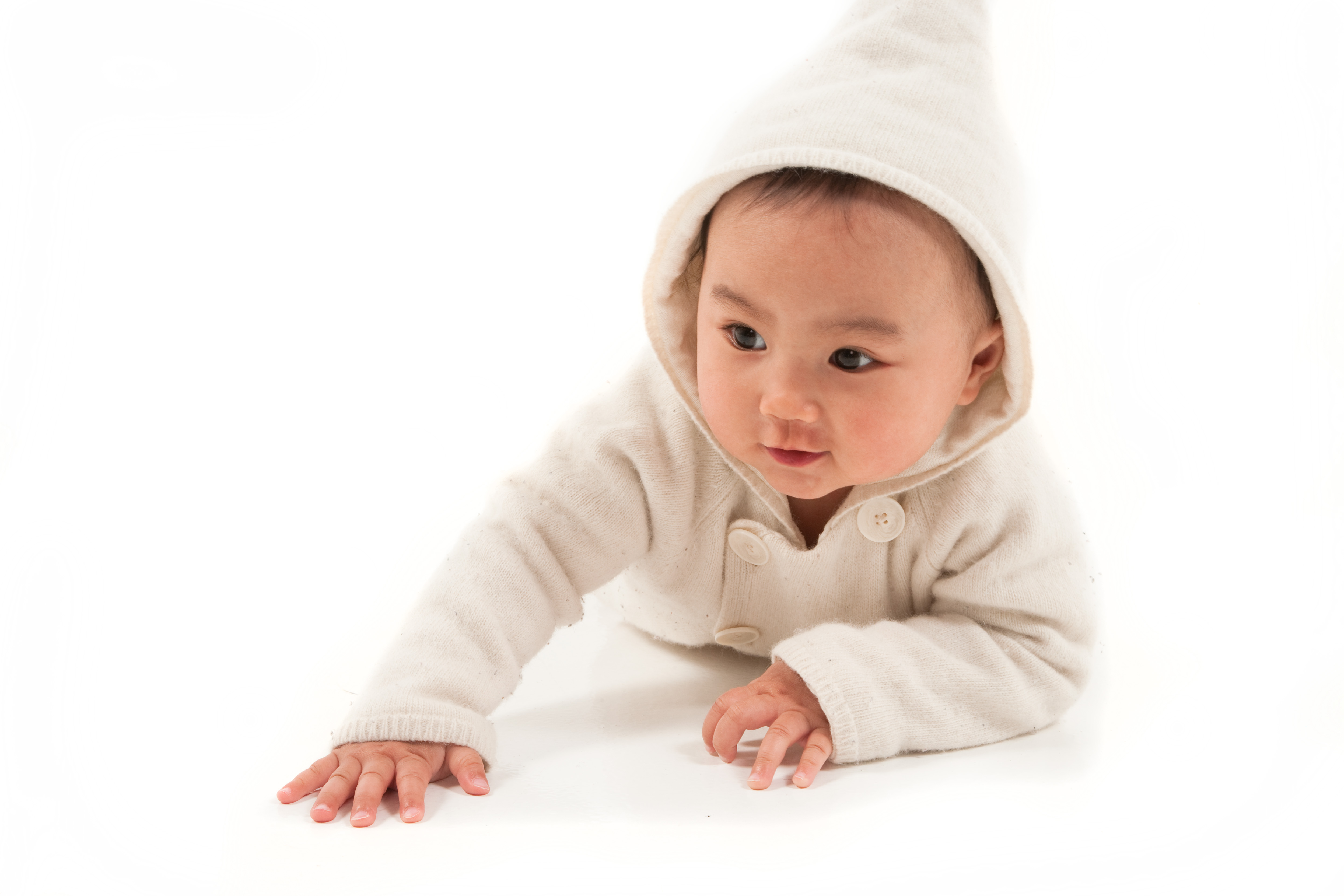 asian baby crawling with white hoodie in studio