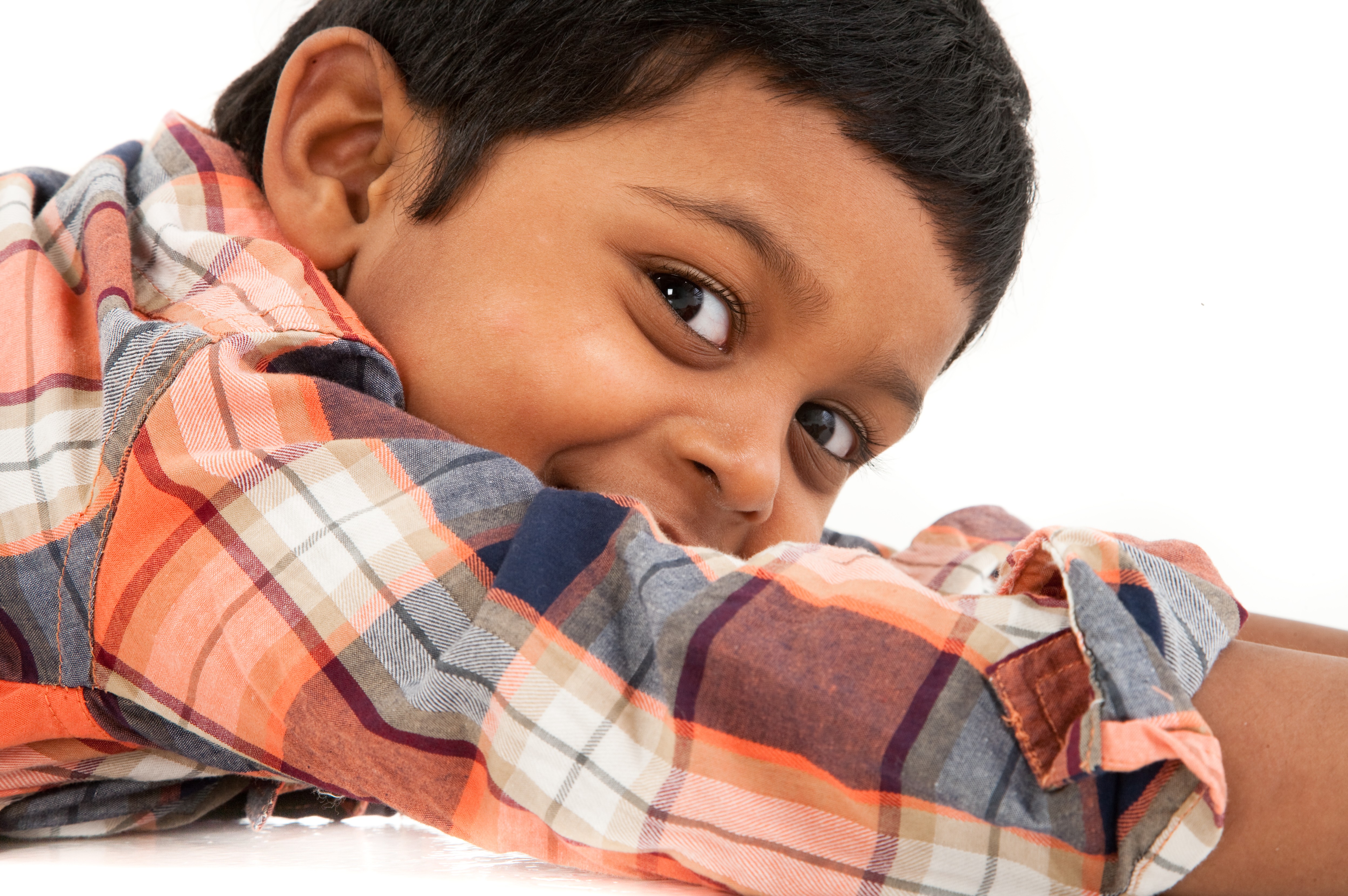 indian little boy studio photoshoot lying down checky smile
