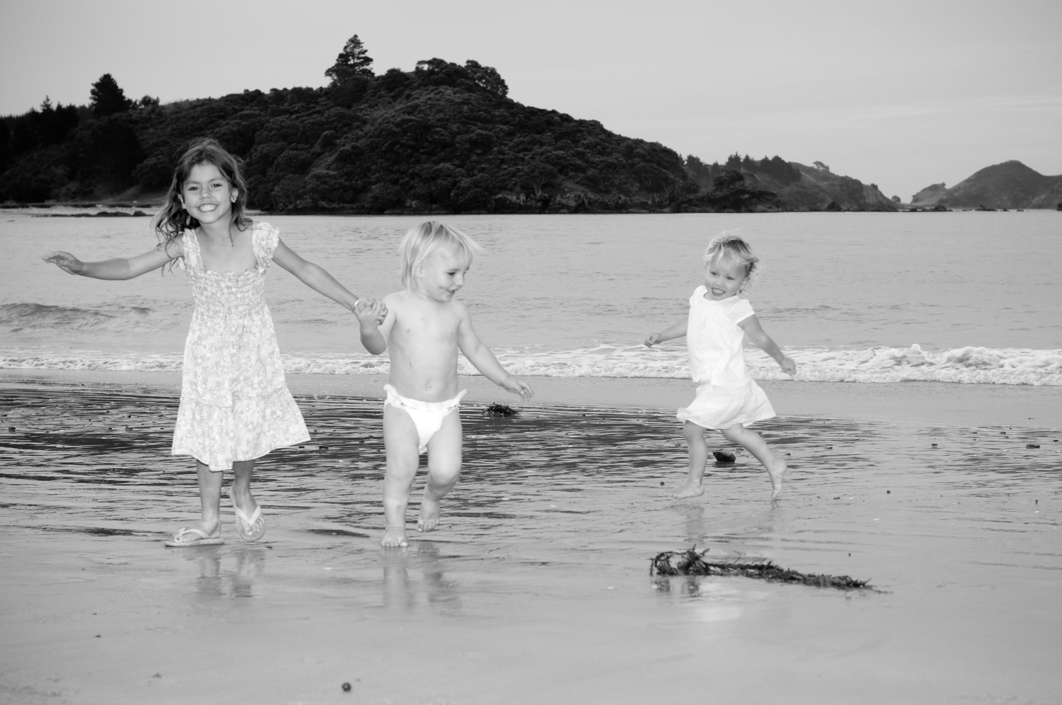 te ngaere bay, bay of island, new zealand, children running by the beach playing