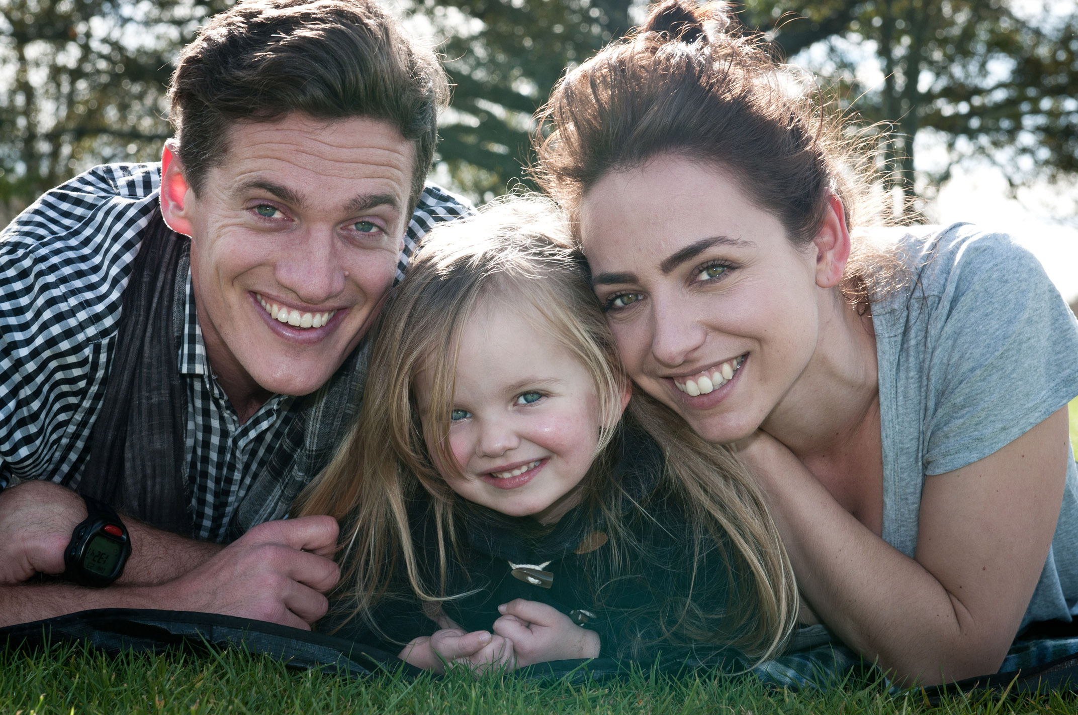 Professional portrait of young family with father mother and daughter in One Tree hill Park, Auckland, New Zealand