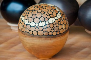 Sphere sculpted on an ancient kauri tree wood sphere. Kauri Kingdom, Awanui, Northland, New Zealand.