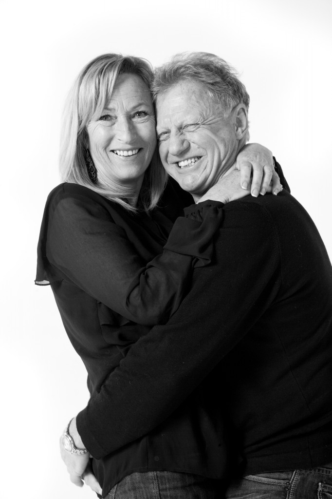 Old couple still in love and happy hugging, blond lady, studio photoshoot in Auckland, new zealand