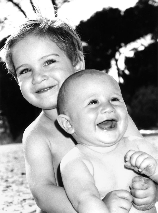 Happy brothers by the beach in Hyeres, beach, France. Black and white.