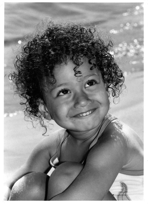 Curly hair tanned little girl, plage de la bergerie, Hyeres, Toulon, South of France, French Riviera. Beach