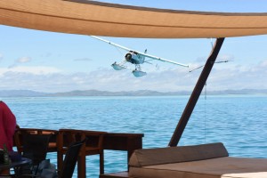 Seaplane flying in a beautiful sea landscape in front of Cloud 9 bar island Fiji