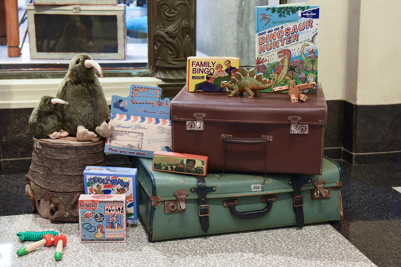 In front of the Auckland Museum's shop suitcase and a variety of games for children putting down on the floor