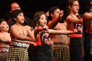 Maori students singing and dancing synchronized traditional maori dance