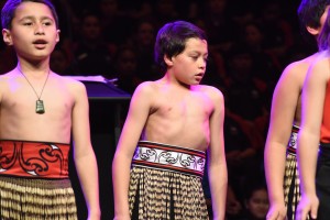 A little maori boy dancing with his classmates
