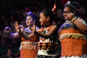 A young girl dancing proudly her traditional pacific island dance