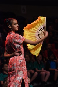 A girl dancing gracefully with a yellow fan Vodafone Event Centre