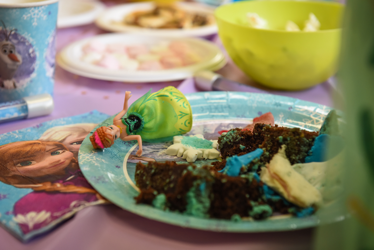 Chocolate cake leftover in a plate with frozen doll